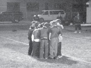 Another Cook County tradition—flag football on Lyle Anderson Field Left: At the recent wrap-up flag football game, the “Blue” team strategizes in the huddle.