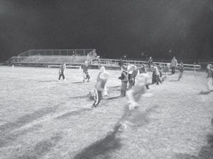 Below: Bradley Wilson gets the snap while his teammates go out for a pass.