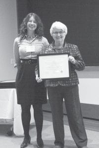 Betty Hemstad (right), past president and museum chair for the Gunflint Trail Historical Society, accepts an award from Bonnie McDonald, director of the Preservation Alliance of Minnesota. The award recognizes the hundreds of volunteers who worked to develop the former Chik-Wauk Lodge to the Chik-Wauk Museum and Nature Center