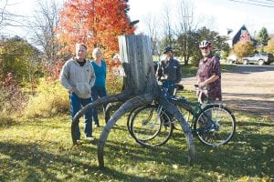 A new sculpture is doing double duty as a bike rack at the Cook County Higher Education North Shore campus at 3rd Street and 3rd Avenue West in Grand Marais. Local artist/metalsmith Don Hammer was commissioned to create the steel structure, and a dedication celebration was held October 13, 2010. (L-R) Don Hammer, Cook County Higher Ed Executive Director Paula Sundet Wolf, Superior North Outdoor Center owner Mark Spinler, and bike enthusiast and Superior North employee Jerry Hiniker.