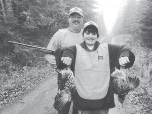 Left: The cold weather didn’t deter these grouse hunters. Dean Holt and his son, Adam, got these two nice birds on Mark Lake Road near Grand Marais on Monday, October 25.