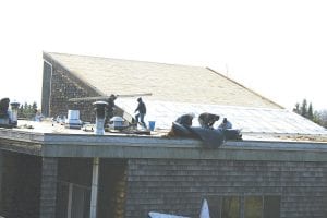 A team of workers wasted little time temporarily covering the Grand Marais swimming pool roof. The pool lost all of its shingles and insulation in the big windstorm on Oct. 27. The pool will be closed until the roof is repaired.