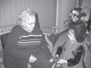 Children and staff from local preschools visited the North Shore Care Center on Halloween. Halloween at the Care Center includes the kids, residents, and the staff at the Care Center, Hospital, and Clinic. Peg Keller, a resident at the Care Center enjoyed giving a treat bag to this little ladybug named Lylla.