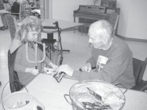 Above: The residents enjoyed the different costumes and had enough candy for all. A little “devil,” Alice Koster receives some Halloween goodies from Byron Whaley. Left: Mrs. H. (Cheryl Hovde) leads her North Shore Preschool students through the halls to visit some of the resident’s rooms. Mrs. H. has been bringing the preschool kids to the Care Center for Halloween for 19 years. Helena Blake, Director of Nurses, had lots of special treats for the children.