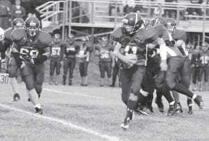 Sophomore quarterback Kale Boomer takes off on a mad-dash while offensive tackle Dene Taylor (69) looks for somebody to block. The Vikings lost their first play-off game, on Oct. 26, to Ogilvie 16-6 but look to be much stronger next year.