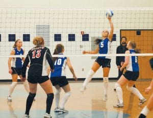 Above: The Vikings defeated the Mesabi East Giants in the first playoff game at home on Wednesday, October 27. (L-R) Cecelia Olson, Linnea Leonard, Ashley “Dish” Deschampe spiking, and Sarah Fagerman. The Vikings went on to face the Albrook Falcons on Friday, Oct. 29. Dish went on a 14-point serving run in that game. Left: Brea Boomer faces two Giants as she tips the ball over the net.