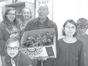 Jana Larson’s fourth and fifth graders recently held a glasses collection to help the Grand Marais Lions share the gift of sight. Members of the glasses committee with Lion Walt Mianowski are (L-R) Abby Prom, Claire Sherburne, Claire LaVigne, (front) Genevieve Neuwirth, and Connor Franks.