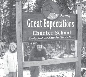 Great Expectations School has two new signs, one on County Road 7 and the other on the Gunflint Trail. Pictured is sign maker Dave Woerheide and his daughter Nina, who is a fifth grade student at GES and helped with some of the painting. In addition to the main panel, the signs also provide a place to announce community events, such as the Greenhouse Sale and Pancake Breakfast held each May. The school hopes the signs will help guests and community members find the school more easily.