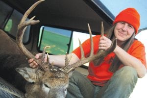 Dayna Gallagher of Hovland with the once-in-a-lifetime buck she got on the second day of hunting season 2010. Right: The deer’s atypical horns, with three sets of brow tines, make it look like a dragon.