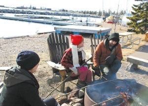 The North House Folk School campus was bustling last weekend as winterers gathered to camp and take classes. Abby Arrowsmith, Erin Adams and Riely McGillievery roast hot dogs and stave off the cold that overtook the Winterer’s Gathering. More Winterer's Gathering images on page A3.