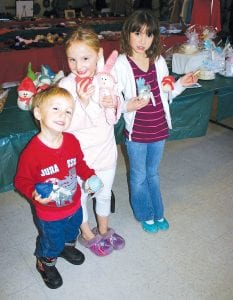 There were lots of delightful goodies and crafts in Schroeder on Saturday, November 20. Upper left: Carter and RaeAnne Silence and Riley Goettl check out the adorable felt snowmen at the North Country Creations Bazaar at the Schroeder Town Hall. Upper right: Schroeder Town Clerk Carol Tveekrem was at the town hall for fun, not work. She stocked up on homemade jelly and jam. Lower left: Sue Hansen and Colleen Brennan, both of Lutsen, enjoy Krumkake made by Leona Sherer and Suzan From at the Cross River Heritage Center. Lower right: Suzan From, museum director, enjoyed offering the Scandinavian delicacy.