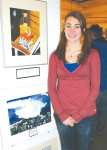 One of the artists, Amber Todd, poses by her beautiful painting of a fisherman at work.