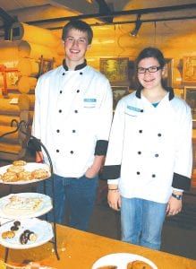 There was also edible art at the opening reception. Culinary arts students presented exquisite desserts. Here, culinary arts students Stein Jacobsen and Sarah Larsen greet guests.