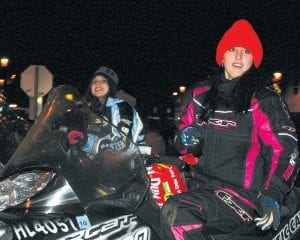 Staff photos/Brian Larsen Above left: Adrianna Berglund (left) and Jade Wolke seem to ride on their snowmobiles with little or no effort. That’s because the girls' snowmobiles were on trailers. The two were representing the Ridge Riders snowmobile club. Above: Santa Claus contemplates baby Hailey Anderson’s Christmas wish, “Peace on earth and goodwill to all men.” Left: One can see why the North Shore Preschool won the “Cutest Kids” category in the Christmas parade. Two cuties here are Iylla Christiansen (left) and Lexi Surbaugh.