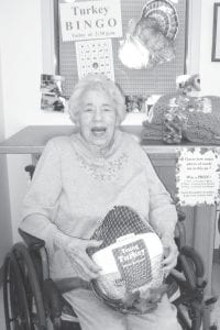 Gertrude Scott was the proud winner of the 10-pound turkey in Turkey Bingo at North Shore Care Center last week. She donated it to her church – First Congregational UCC – for its annual Community Thanksgiving dinner. Gert also won an afghan for guessing the closest number of candy corn in a jar. The second and third place winners were Jane Backstrom and Lucille Hunt—both also won beautiful afghans.