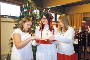 The 36th Julefest was held at Bethlehem Lutheran Church in Grand Marais on Saturday, December 11. This year’s St. Lucia was Josie Freeberg. Her attendants (checking out the sun-colored St. Lucia buns) are MaeAnna LaFavor (left) and Shae Morawitz. See more Julefest photos on page A3.