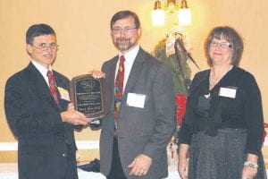 Dr. John Ipsen, Lake Superior Medical Society president, presents the Physician of the Year award to Dr. Paul Terrill. With Dr. Terrill is his wife Jill Terrill.