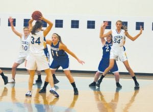 Taylor Ryden (11) guards Esko’s Danielle Salo (34) as Bekah Laky (21) guards Esko’s Savanna Trapp. Laky, who stands 5’ 6”, comes up to the armpits of Trapp, who is 6’ 8”.