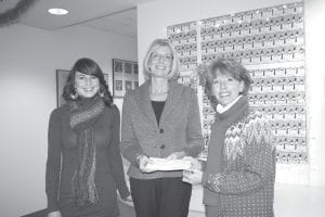 Members of the Chateau LeVeaux Homeowners Association gathered donations for the Cook County Health and Human Services Emergency Fund. Presenting the check is association member Nancy Grabko (right) to Health & Human Services Director Sue Futterer (center). With them is Barbara Jean Johnson of WTIP community radio, whose series Living on the Edge inspired the donation.