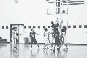 Even though Ryan Martinson (3) didn’t get this rebound, he dominated play underneath in the game against Mountain Iron- Buhl. Kale Boomer, who can barely be seen in the picture, grabbed this rebound while both David Bergstrom (21) and Will Petty (33) were ready to crash the boards. The Vikings employ a “team” rebounding philosophy, which often results in them getting more rebounds than taller opponents.