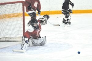 Above: Goalie Chase Gwash prepares for a save. Left: The team at the Two Harbors tournament: (L-R, front) Noah Furcht, Tucker Foley, Chase Gwash, Ella Sporn. (L-R, middle) Trevor Berglund, Ryan Bilben, Lucas Sheils, Nate Bilben, Jayden Grivette, John Vander Heiden. (L-R, back) Coach Andrew Bilben, Coach Nate Sheils, Coach Matt Bronikowski. (Not pictured: Alyssa Lashinski)