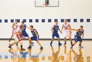 Above: Kale Boomer puts pressure on the ML/WR ball handler while Dylan Quaife (10), Colin Everson (30), and Ryan Martinson (3), shut down the inside. The boys played tough but lost 52-38 to Moose Lake/Willow River last Tuesday night. Right: Senior guard Ryan Martinson gets ready to blow by ML/WR forward Taylor Mattison for a lay-up. Martinson scored 8 points against the Rebels last Tuesday night.