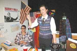 Harvey Milk ( Will Brandenburg) talks to the public at his San Francisco supervisor’s office. He and his partner Scotty Smith (David Bergstrom) ran his campaign on a gay rights platform.