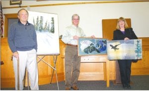 Above: Three pieces of art were donated to beautify the Cook County courtroom walls in November 2010. Attorneys were encouraged to make the contributions by retiring Judge Kenneth Sandvik. (L-R) Richard Swanson with Afternoon Shadows; Scott Smith with Susie Islands; and artist Marie Westerman with the weaving Raven Flight, donated by Mike Hero.