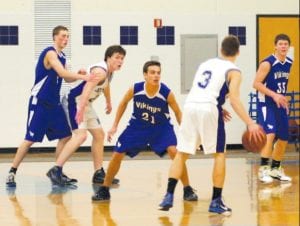 David Bergstrom (21) defends against Silver Bay guard Ryan Thun (3) in the game played at home last week. Ryan Martinson and Will Petty (33) also defend the basket. Good defensive pressure and some fine outside shooting led to a 59-40 win for the Vikes.