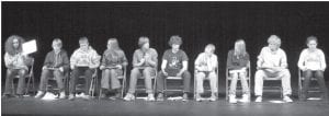 The finalists in the Cook County Middle School Geography Bee answered questions orally and by writing their answers on a note board. Above, Brenna Hay shows her answer. Her fellow finalists nervously await their turn to show their answers— Will Lamb, Lars Scannell, Selien Morawitz, Sean MacDonell, Will Seaton, Hunter Monson, Lauren Thompson, Noah Warren, Danielle Hanson.