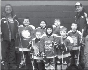 The Cook County M1s had a great time at the Mite 1 Superstar Silver Bay Jamboree! Above: (L-R, front) Andrew Hallberg, Ryan Christiansen, Koke Anderson. (L-R, back) Coach Tom Jack, Patrick Pierre Jr, John Pierre, Tanner Berglund, Kevin Viren, Coach Patrick Pierre Sr. (Not pictured: Coach Brian Cooley, Bridget Cooley, Drew Pelletier). Left: Brothers Patrick (front) and John Pierre relax after some great action on the ice in the Silver Bay Jamboree.