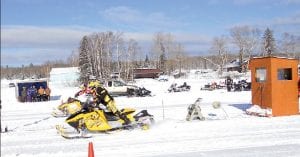 The Cook County RidgeRiders Snowmobile Club wasn’t sure what to expect for this year’s Snowmobile Drag Races on Devil Track Lake on Saturday, January 22. With extremely low temperatures and high winds predicted, the club didn’t know if racers would come out for competition. However, there was a great turnout and enough racers to have some challenging races.