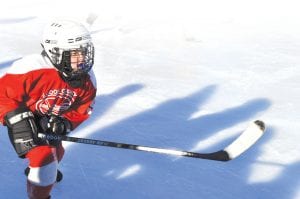 Ella Sporn flashes some of her fine skating form while she chases a puck down the ice. Ella plays for the Mite 2 hockey team.