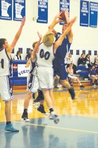 Dylan Quaife goes up high over two Mesabi East defenders and scores two points for the Vikings. Quaife, like the rest of his teammates, played solid basketball throughout the night, but the team couldn’t quite overtake its rivals.