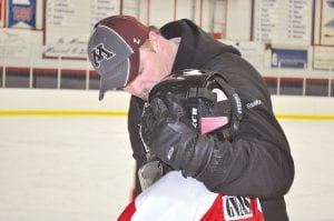 Coach Bilben encouraging Chase Gwash after a game well played.