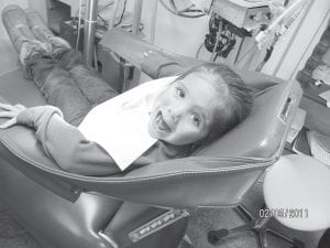 Throughout the month of February the Grand Marais Family Dentistry gave smiles to 40 Cook County children with Give Kids A Smile. Above, MaTaya Fairbanks says “Ahhhh”, and below, Rachel Hovde looks on as Dr. Alyssa Hedstrom examines her daughter, Kyli.