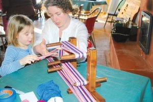 Above: Families and kids were in abundance on the North House campus over the weekend as part of the first Northern Fibers Retreat. Here, Amanda Hand and daughter Elsa Garry weave on a loom during Saturday’s Fibers for Kids program, which was taught by six members of Cook County’s Northwoods Fiber Guild.