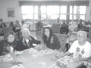 Students from the School District 166 After School Lounge program visit residents at North Shore Care Center twice a month during the school year. Students and residents do a variety of activities together such as games, crafts, exercise group, and community service projects. Enjoying snacks and bingo are (L-R) Mason Liljestrand, Ardis David, Alexis Everson and Delores McLean.