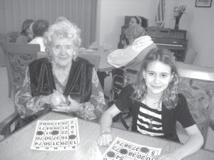 Dorothe Vaughn gets her bingo chips ready while playing with Lucy Shaw.