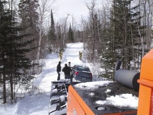 At least twice in February motorists went astray and got stuck on area snowmobile trails. The folks pictured here took a turn off the Caribou Trail in Lutsen onto Hunt Road (which is actually a private driveway) and then onto the snowmobile trail. Brett Hansen, groomer for the Lutsen Trailblazers Snowmobile Club, was called to pull them out with the club’s 2010 Tucker Terra-2000 groomer.