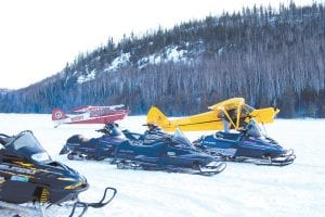 Above: Carbine’s Fish Fry on McFarland Lake was the place to be on Saturday, March 5. Snowmobilers came from all over the county— the Cook County Ridge Riders started at Devil Track Landing and the Grand Portage Trail Riders traveled from the Grand Portage Lodge. Other people came by car, four-wheeler and plane! Peter and Dena Schliep of Grand Marais landed on the ice and a little while later, these two planes—a Piper Super Cub and an Aviat Husky arrived. The pilots are from Wisconsin. They heard about the Carbine’s fabulous fishcakes from friends on Devil Track Lake.