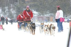 Mushing for a cure! Frank Moe of Moetown Kennels and Jessica Berg-Collman take off in the sled dog fun run fundraiser benefiting the National Breast Cancer Foundation on Saturday, March 12. The weather was perfect for the run between Gunflint and Poplar Lakes and for all the festivities before, after, and during the 2011 Mush for a Cure. See more on page B7.