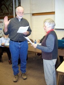 ISD 166 Board Chair Mary Sanders swears in the newest school board member, Terry Collins of Grand Marais, on March 14, 2011. He will be filling the term of Rod Wannebo, who retired from the board last month.