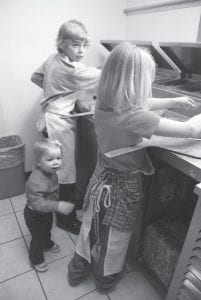 Above: Piper wants to know where her dishrag is, but big brother Ethan and sister Ella are too busy to let their little sister help. Besides, Piper would probably spend more time sucking on the rag than drying dishes anyway. Maybe next year she’ll be big enough to lend a hand.