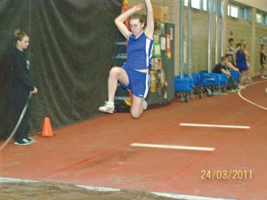 Amber Todd (left) shows off her long jump form while Ashley Deschampe (above) gets the girl’s sprint medley relay team off to a fine start. Todd finished third overall and the sprint medley team placed second.