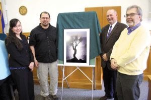 Celebrating the Grand Portage community’s donation of a Travis Novitsky photograph is (L-R) Grand Portage Tribal Council Secretary-Treasurer April McCormick, Travis Novitsky, Judge Michael Cuzzo, and retired Judge Kenneth Sandvik.