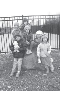 Left: A number of children brightened the Good Friday event—walking, running, and dancing along the route. Here at the stop to pray for the congregation that meets at the Cook County Community Center are (L-R, front) Boston Henneman, Joshua Pike, Trinity Henneman, Rachael Pike. (L-R, back) Jonah Schmidt, Genevieve Silence.