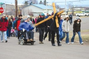 The Annual Community Crosswalk and Good Friday Service was held on Friday, April 22. Approximately 50 community members gathered for the procession from church to church in Grand Marais, pausing to offer prayers for each congregation. Nancy and Tim Ramey took a turn carrying the cross on the uphill section. See more about the event on page A4.