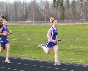 Above: Shelby Ahrendt ran a fine leg in the girls' 4x800 race at the Hermantown Invitational held Friday, April 29. The girls placed 5th out of 12 teams.