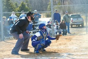 Left: In a game against Carlton, Anna Carmen waited patiently for the ball from her catcher’s position while the ump gets ready to call balls or strikes. Above: When she’s not pitching, Kristina Rude wields a mighty bat for the Vikings. Although the girls only have two wins, they have been close in several other games.